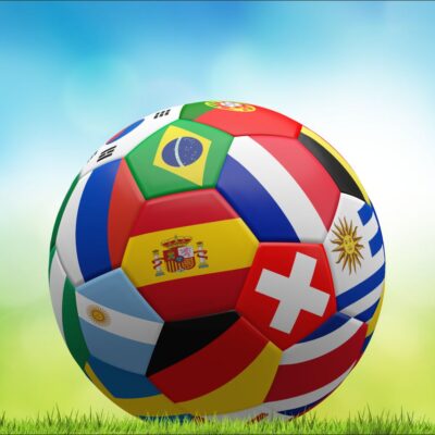 fototapeta piłka nożna we flagi na zielono niebieskim tle