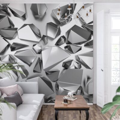 Fototapeta 3D do salonu przedstawiająca abstrakcyjne, szare bryły geometryczne i kryształy, aranżacja wnętrza z białą kanapą i roślinami.